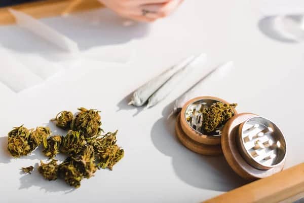 weed buds on table with 3 rolled joints